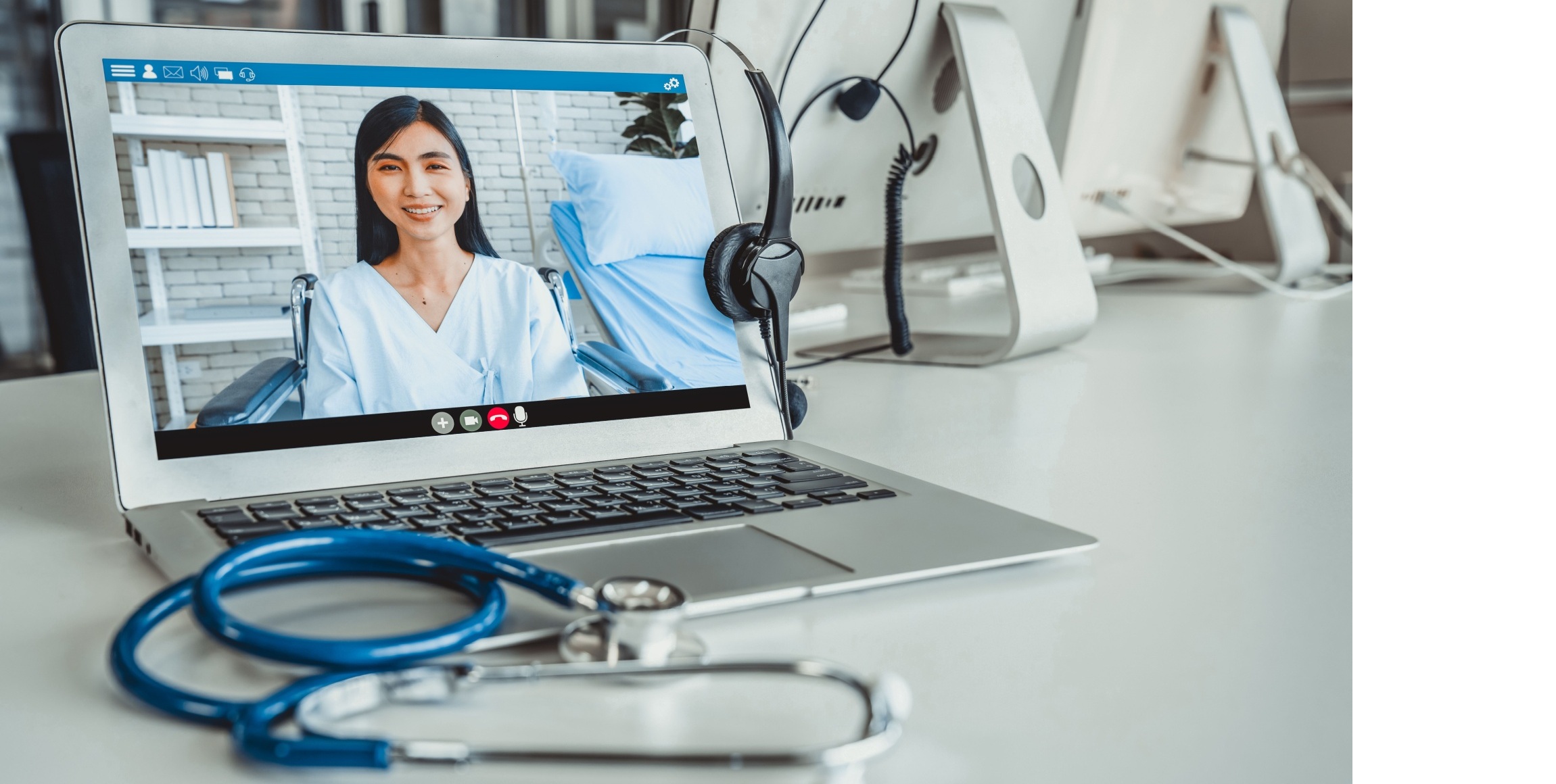Clinician on a video consultation via laptop, representing digital healthcare workforce during large-scale redundancy programme