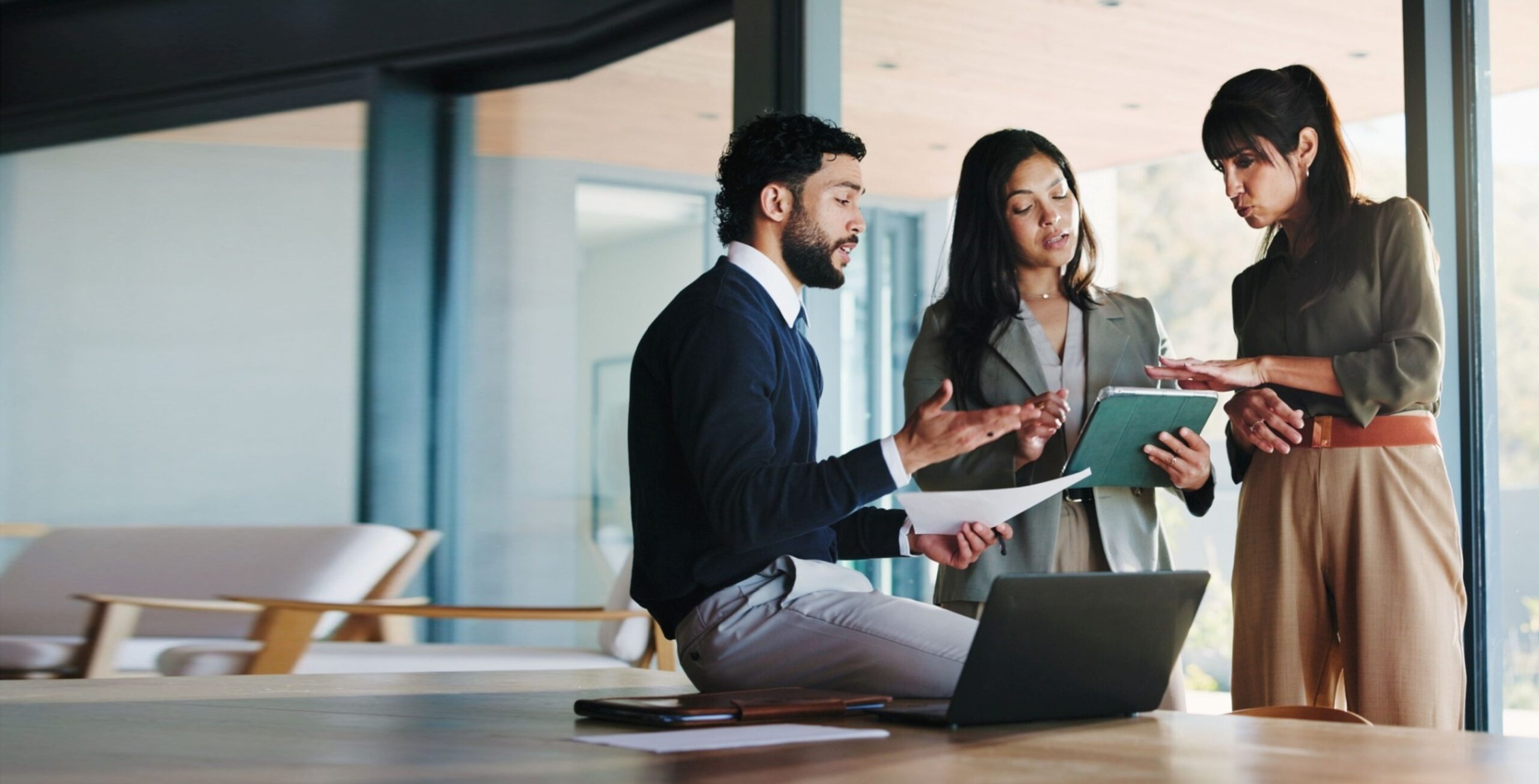 Consultants reviewing documents together in a modern office setting
