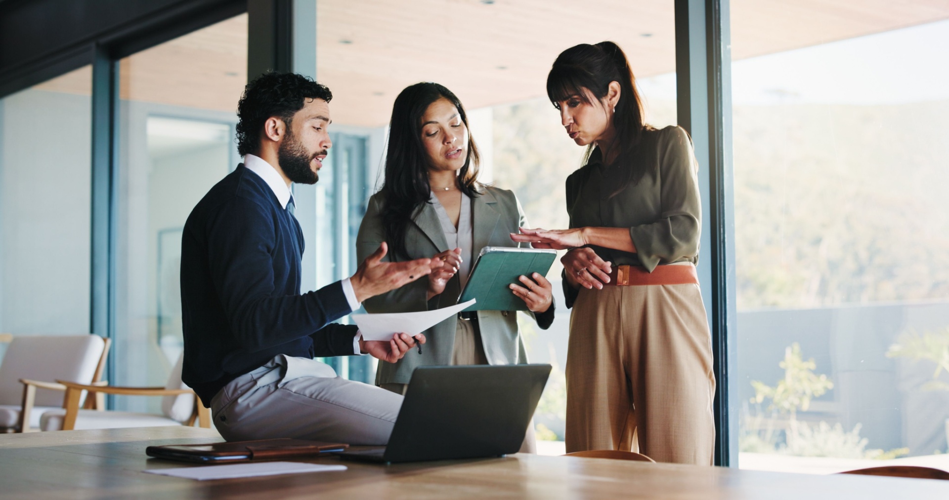 Consultants reviewing documents together in a modern office setting